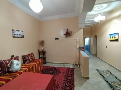 a living room with a couch and a table at Desert Dream Apartment in Merzouga