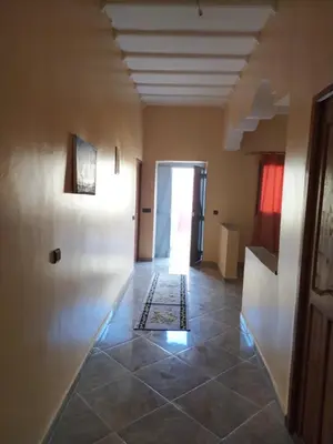 a hallway with a door and a tile floor at Desert Dream Apartment in Merzouga