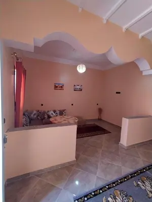 a living room with a couch and a table at Desert Dream Apartment in Merzouga