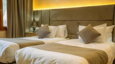 a hotel room with two beds with white pillows at Hôtel Reda Zagora in Zagora
