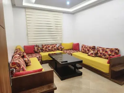 a living room with a couch and a table at Villa Paradis Fès