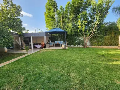 a yard with a house with a large lawn at Villa Paradis Fès