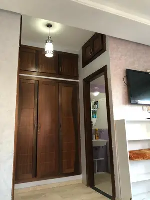 a room with wooden doors and a tv on a wall at Nas fez in Fès