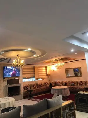 a living room with a couch and a tv at Nas fez in Fès