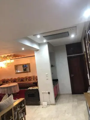 a living room with a large room with a door at Nas fez in Fès