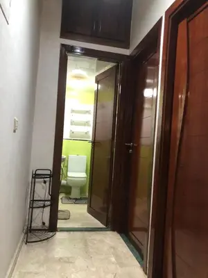 a bathroom with a toilet and a door to a room at Nas fez in Fès