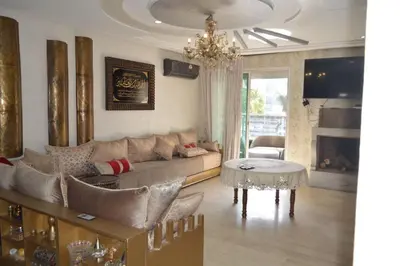 a living room with a couch and a table at Nas fez in Fès