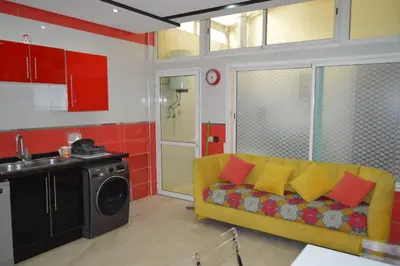 a living room with a yellow couch in a kitchen at Nas fez in Fès