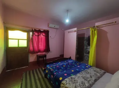 a bedroom with a bed and a door and a window at Le LAC Auberge Camping Todra in Tinerhir