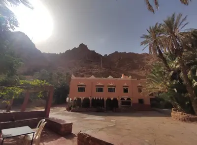 a house in the desert with mountains in the background at Le LAC Auberge Camping Todra in Tinerhir