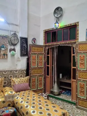 a bedroom with a bed and a couch at Maison Soulaîmi in Fès