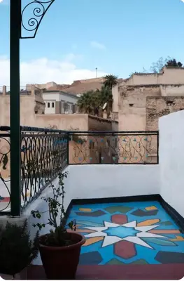 a view from a balcony with a painting on the floor at Maison Soulaîmi in Fès