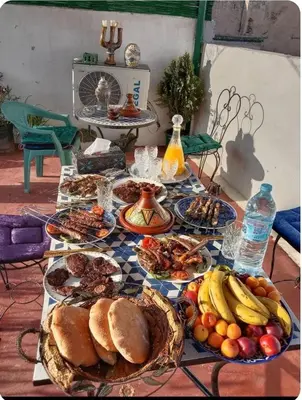 a table with many plates of food on it at Maison Soulaîmi in Fès