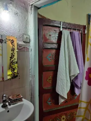 a bathroom with a sink and a towel rack at Maison Soulaîmi in Fès