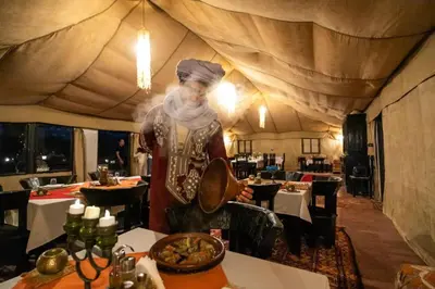 a man standing in a room in a restaurant at Sahara Spirit luxury Camp in Merzouga