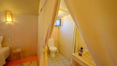 a small bathroom with a toilet and a sink at Sahara Spirit luxury Camp in Merzouga
