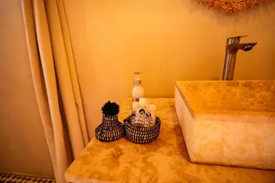 a bathroom counter with a sink and two toiletries at Sahara Spirit luxury Camp in Merzouga