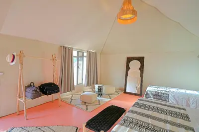 a living room with a bed and a room with at Sahara Spirit luxury Camp in Merzouga