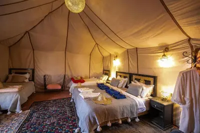 a bedroom with two beds in a tent at Sahara Spirit luxury Camp in Merzouga