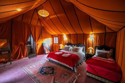 a bedroom with two beds in a tent at Sahara Spirit luxury Camp in Merzouga