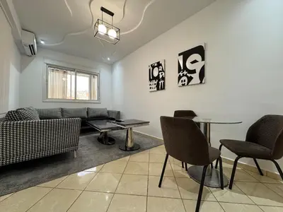 a living room with a couch and a table and chairs at Dana in Beni Mellal