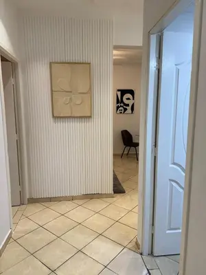 a hallway with a wall with a painting on it at Dana in Beni Mellal