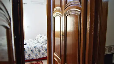 a wooden closet with a bed in a room at City Center Stay - Résidence Omar 1 by ZenStay in Fès