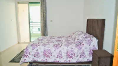 a bedroom with a bed with a purple blanket at City Center Stay - Résidence Omar 1 by ZenStay in Fès