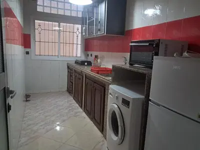 a kitchen with a washer and dryer in it at Apartment in downtown Fez in Fès