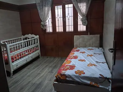 a bedroom with a bed and a crib at Apartment in downtown Fez in Fès