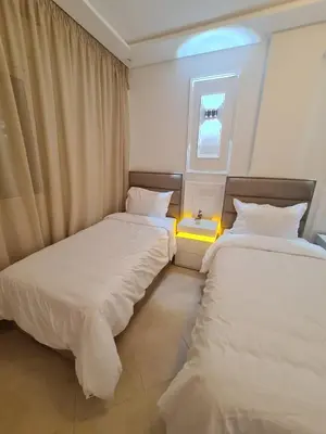 two beds in a room with a window at Dream apartment in Meknès