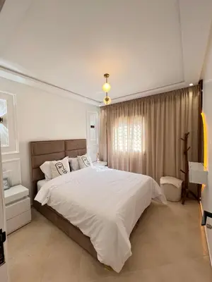 a bedroom with a large bed and a window at Dream apartment in Meknès