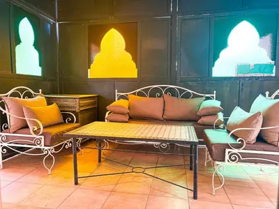 a room with a couch and chairs and lights at Gueliz 2-BR Apt Majorelle Garden Spacious Terrace in Oulad Akkou
