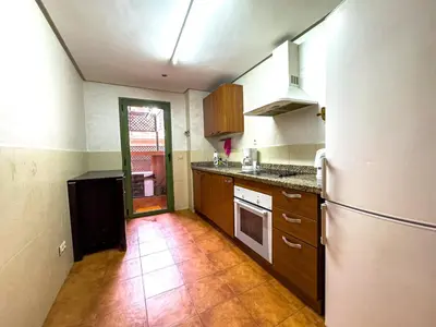 a kitchen with a refrigerator and a tile floor at Gueliz 2-BR Apt Majorelle Garden Spacious Terrace in Oulad Akkou