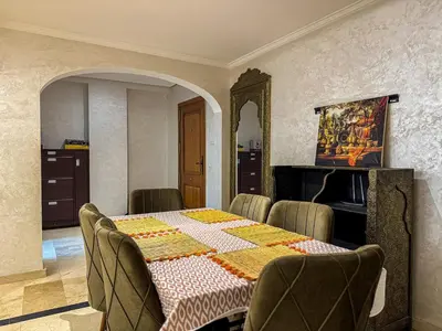a dining room with a table with chairs and a tableablish at Gueliz 2-BR Apt Majorelle Garden Spacious Terrace in Oulad Akkou
