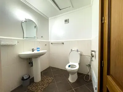 a white bathroom with a toilet and a sink at Gueliz 2-BR Apt Majorelle Garden Spacious Terrace in Oulad Akkou