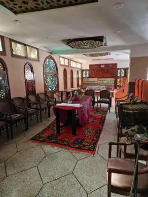 a room with a table and chairs and a piano at Café restaurant in Issafene