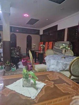 a living room with a bed and a table at Café restaurant in Issafene