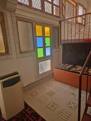 a room with two windows and a stair case at Café restaurant in Issafene