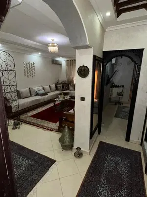 a living room with a couch and a table at Appart familial moderne de luxe Location journalière ou longue durée in Khemisset