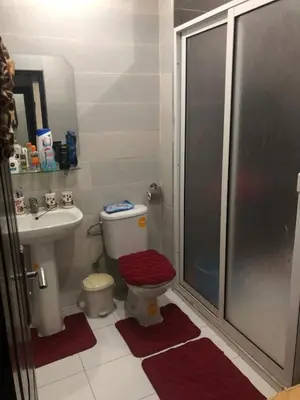 a bathroom with a shower and a toilet and a sink at Appart familial moderne de luxe Location journalière ou longue durée in Khemisset