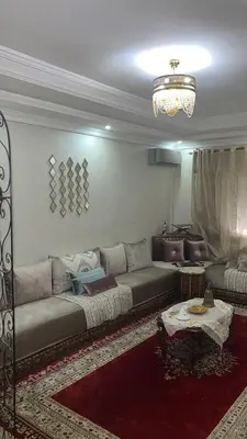 a living room with a couch and a table at Appart familial moderne de luxe Location journalière ou longue durée in Khemisset