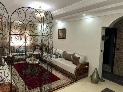 a living room with a couch and a iron gate at Appartement moderne et entièrement meublé in Khemisset