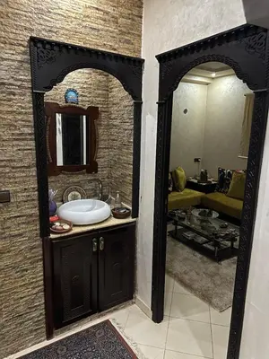 a bathroom with a sink and a mirror at Appartement moderne et entièrement meublé in Khemisset