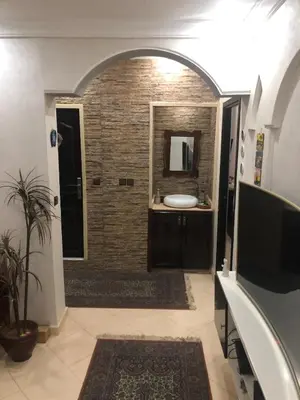 a bathroom with a sink and a mirror at Appartement moderne et entièrement meublé in Khemisset