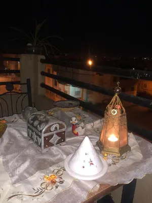 a table with a table cloth with a lantern on it at Appartement moderne et entièrement meublé in Khemisset