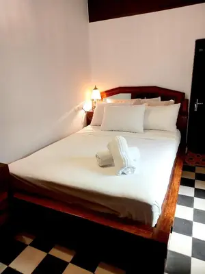 a bedroom with a large bed with white sheets at Hadi house in Fès