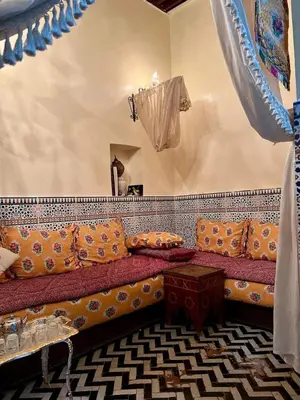 a room with a couch with pillows on it at Hadi house in Fès