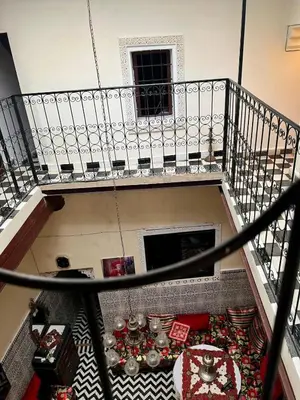 an overhead view of a room with a table and a balcony at Hadi house in Fès