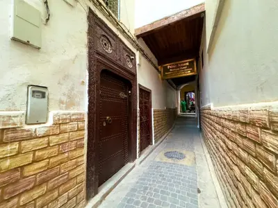 an alley with a brown door on a building at vintage in Fès